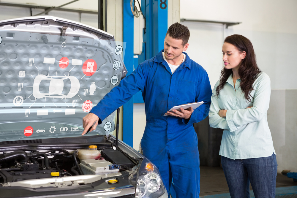 Engineering interface against mechanic showing customer the problem with car
